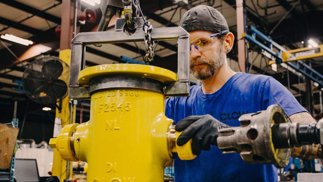 An employee working on putting together a fire hydrant.